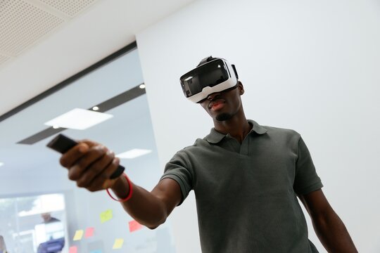 Black man experiencing virtual reality with controller