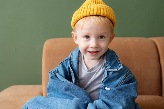 A cheerful child in a yellow cap