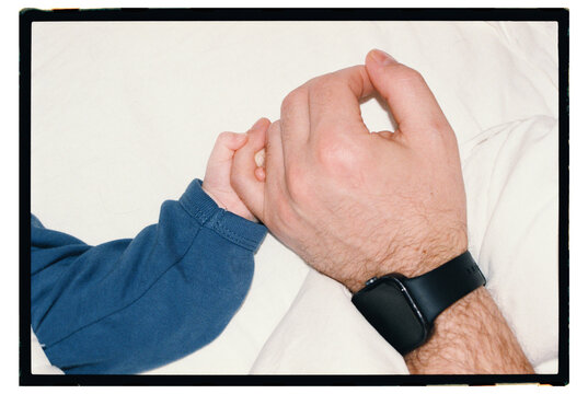 Holding hands between a child and an adult