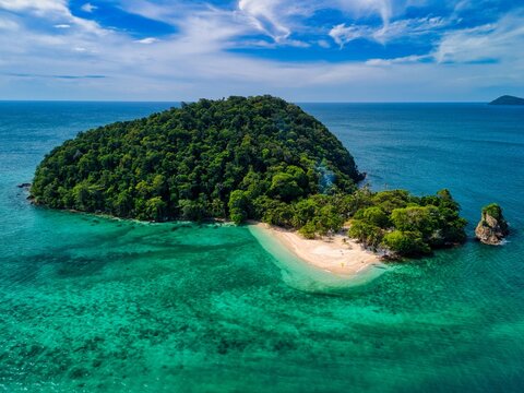 Aerial view of the lush tropical island of Ko Rayang Nok featuring a pristine white sand beach and crystal clear turquoise waters under a blue sky Ko Mak, Trat, Thailand.