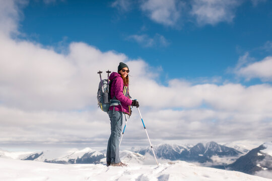 Confident Female Hiker Smiling at a Snowy Summit