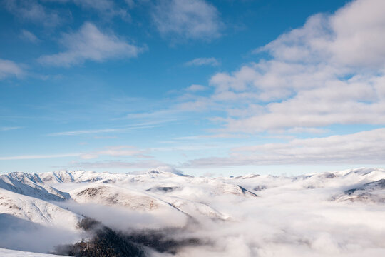 Snow mountain range Floating Above sea of clouds
