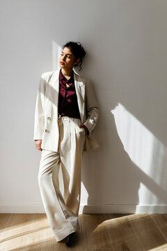 Woman posing in professional cream suit business attire