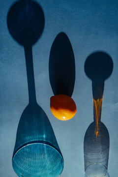 Shadows and shapes created by glass and fruit on a surface