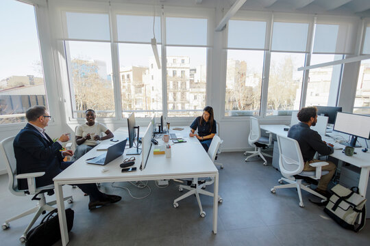 Professionals collaborating in a modern coworking office space