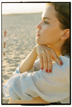 Close profile portrait of woman at sunset beach