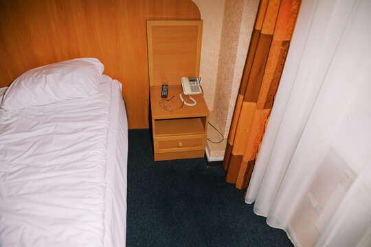 Simple Room With Bed and Nightstand in a Hotel