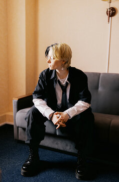 Person Sitting on a Couch in a Room With Soft Lighting