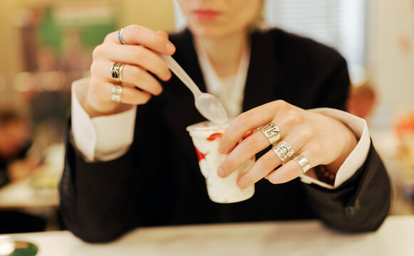 Person Enjoying Yogurt in a Cafe During Lunchtime