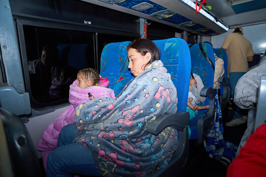 Mother and daughter traveling by bus at night