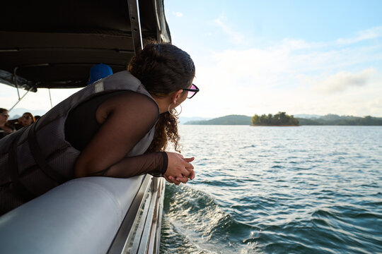Woman on boat enjoying scenic lake journey