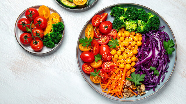 colorful healthy food composition with multiple plates, variety vegetables, top view flat lay