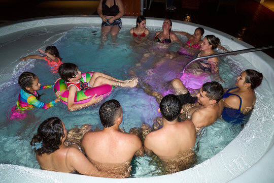 Diverse multi-generational family group enjoying hot tub