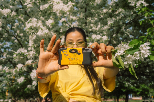 Young Woman Taking Selfie with Disposable Film Camera