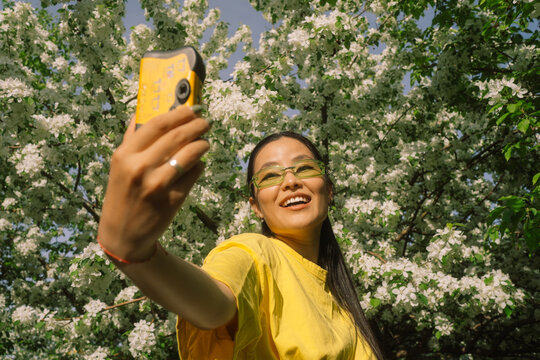 Young Woman Taking Selfie with Disposable Film Camera