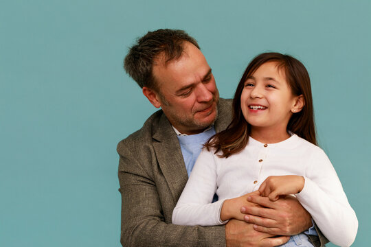 Father Shares a Moment With Daughter in Studio Setting