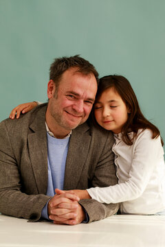Father and Daughter Share a Moment Together in a Studio Setting