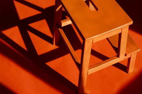 Wooden Stool on Orange Floor 