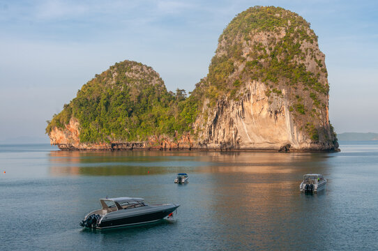 Limestone island cliffs and speedboats near Krabi, Thailand 