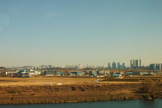 City Skyline Beyond Dry Fields and River
