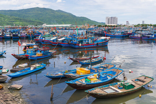 Groups of colorful Vietnamese fishing boats moored in a harbor