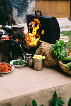 Roasted cherry tomatoes, fresh thyme, spicy tomato sauce on the table.