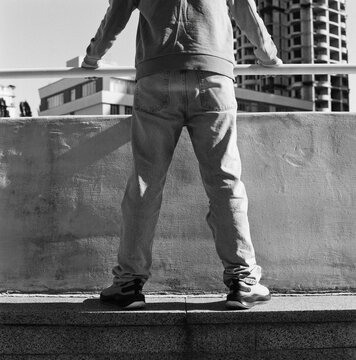 Teen Overlooking City from Terrace