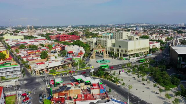 Aerial film of downtown Zapopan, located near Guadalajara city; houses, avenues and streets can be seen in the background, the Basilica of the Virgin of Zapopan city, the subway crosses
