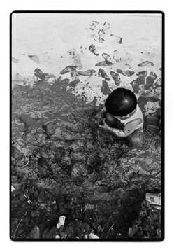 Child Playing in Muddy Ground