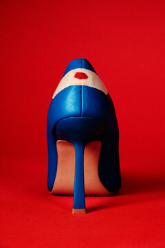 a blue high heel with a blood-stained bandage