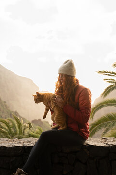 Woman affection cat sunset