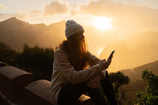 Woman phone sunset viewpoint