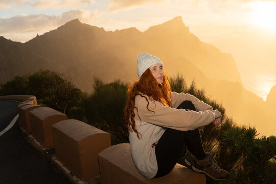 Woman sitting mountain sunset