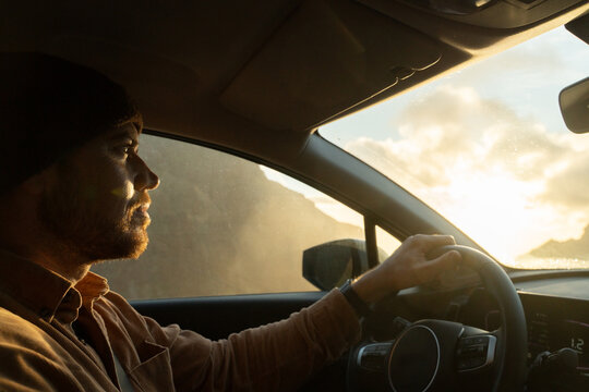 Man driving car sunset