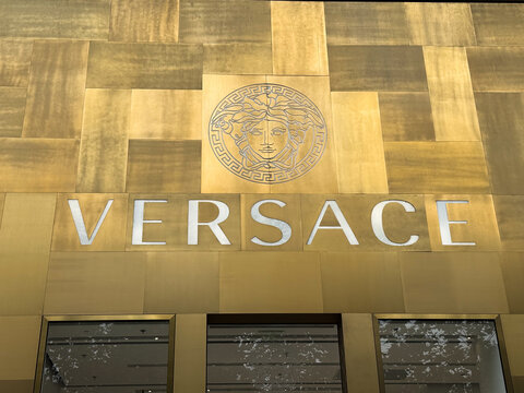 Shanghai, China - November 24, 2025: Versace Store Golden Facade with Medusa Head Logo Close Up