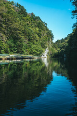Obraz premium Serene Geibikei Gorge River with Lush Green Cliffs in Iwate Japan