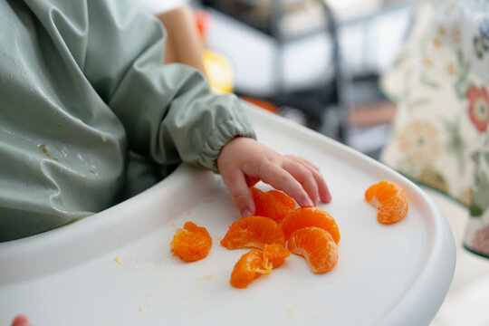 Small hand exploring orange fruit