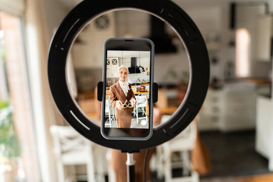 Phone screen showing senior woman video