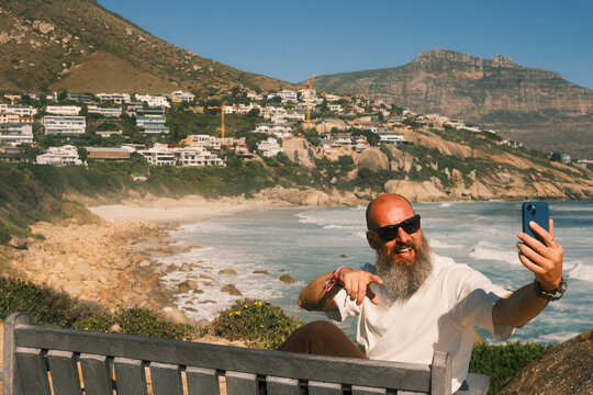 Bearded man video talking on the phone in Cape Town
