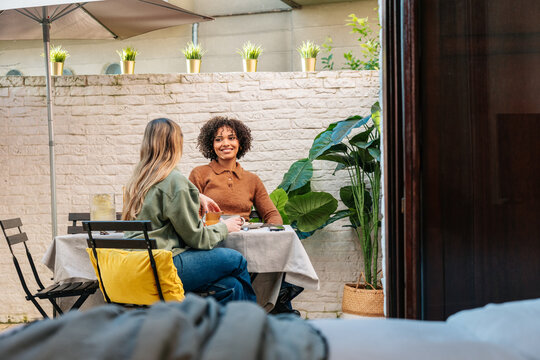 Friends enjoying coffee and conversation on a patio