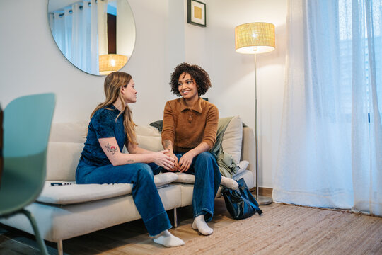 Friends relaxing at home, having a deep conversation