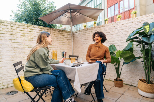 Friends enjoying coffee and conversation on a patio
