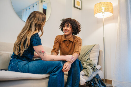 Friends enjoying conversation laughing together at home