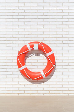 Lifebuoy on a white brick background