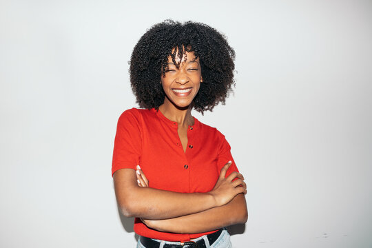 Happy black woman laughing with arms crossed