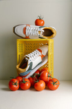 Still life of colourful sneakers and tomatoes