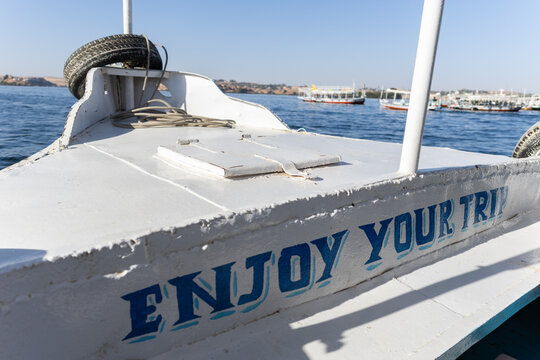 Boat on Water With Message 'Enjoy Your Trip' at the Dock