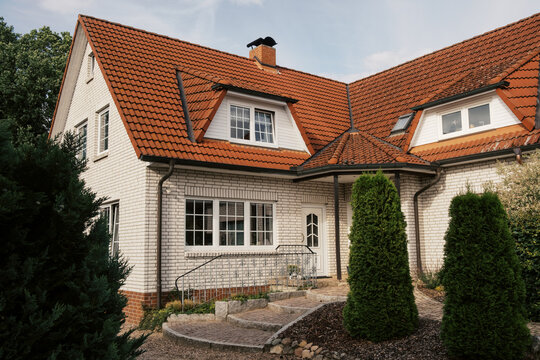 Exterior or White House with red roof in germany