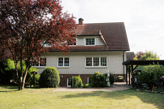 Exterior or White House with red roof in germany