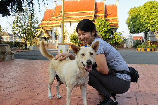 Person with Dog outside Thai Temple
